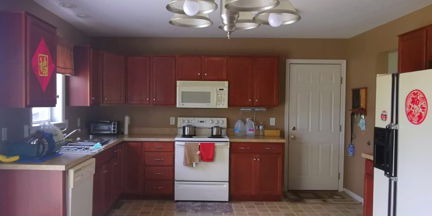 Kitchen with wood-tone cabinets and white appliances