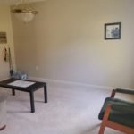 Carpeted living room with coffee table and seating