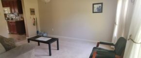 Carpeted living room with coffee table and seating