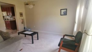 Carpeted living room with coffee table and seating