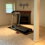 Basement with workout equipment and fireplace