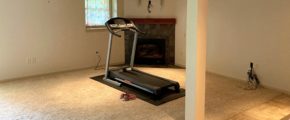 Basement with workout equipment and fireplace