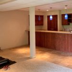 Basement with small kitchenette and workout equipment