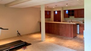 Basement with small kitchenette and workout equipment