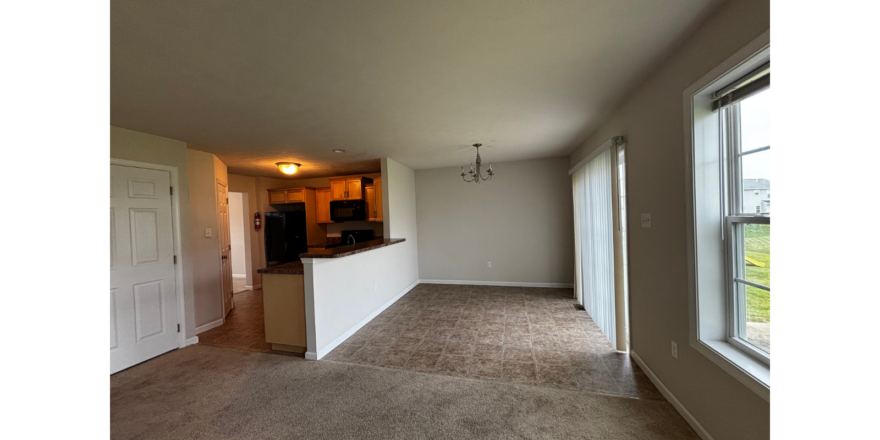 an empty living room with a large window