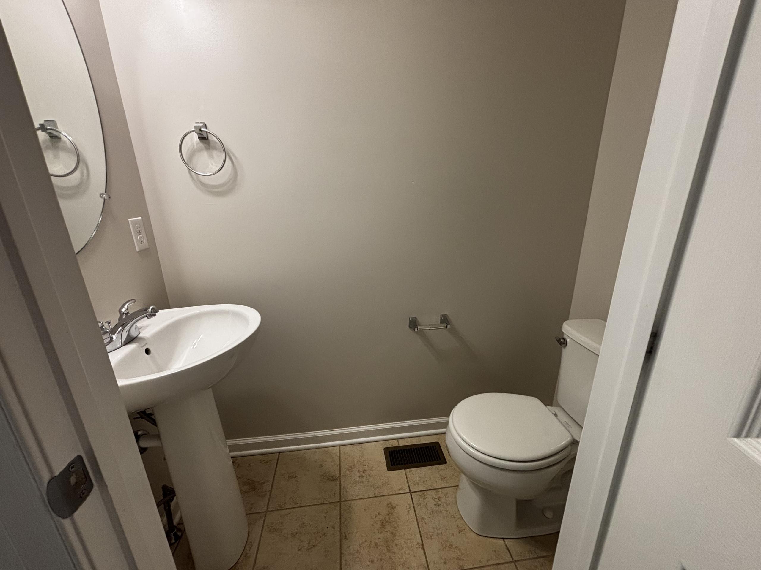 Powder room with pedestal sink and toilet