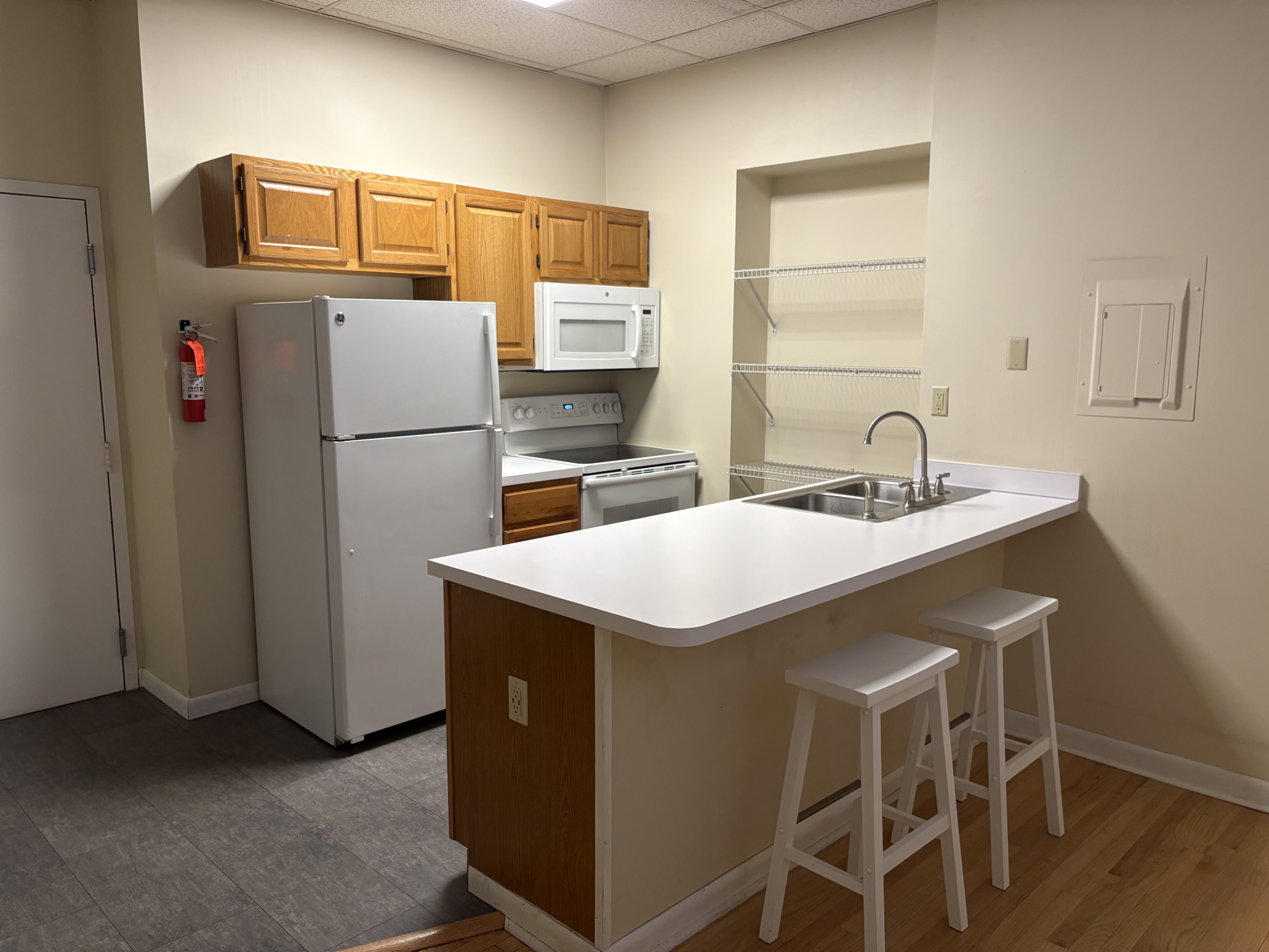 Kitchenette with white refrigerator and island