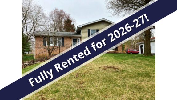 a house with a blue ribbon in front of it