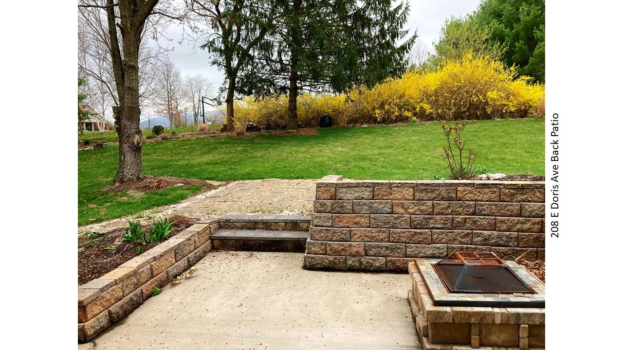 Back patio with fire pit at 208 E Doris Ave