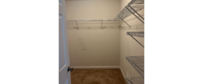 a walk in closet with a closet door open
