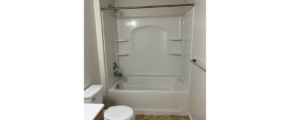 a bathroom with a toilet, shower, and sink