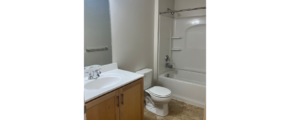 a bathroom with a toilet, sink, and bathtub
