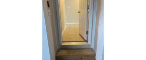 a hallway leading to a bedroom and a bathroom