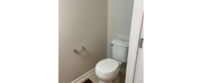 a white toilet sitting in a bathroom next to a shower