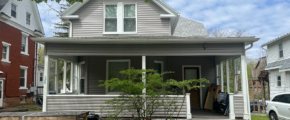 A house with gray siding and a porch