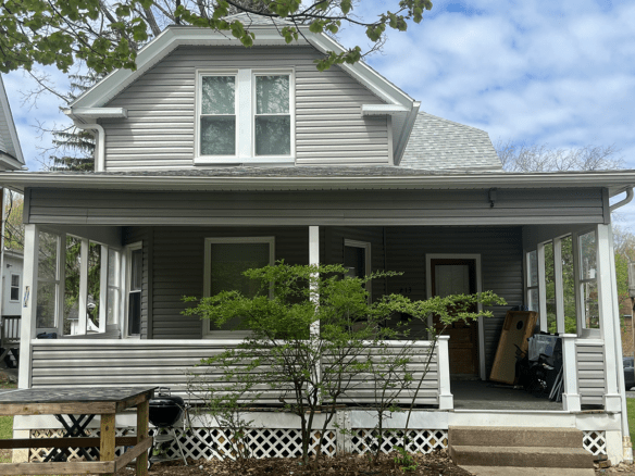 A house with gray siding and a porch