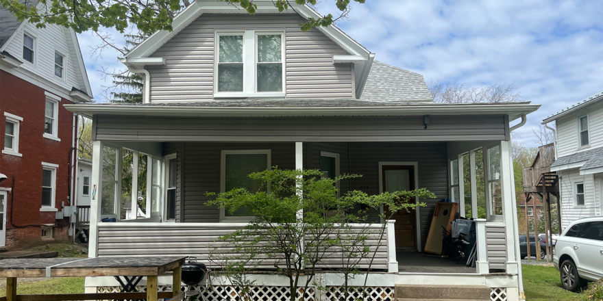 A house with gray siding and a porch