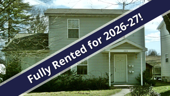 a house with a blue ribbon in front of it