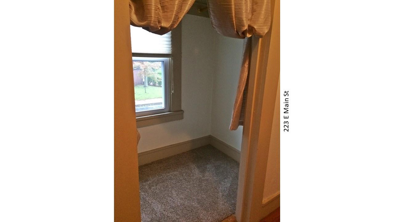 Small room with window and carpet