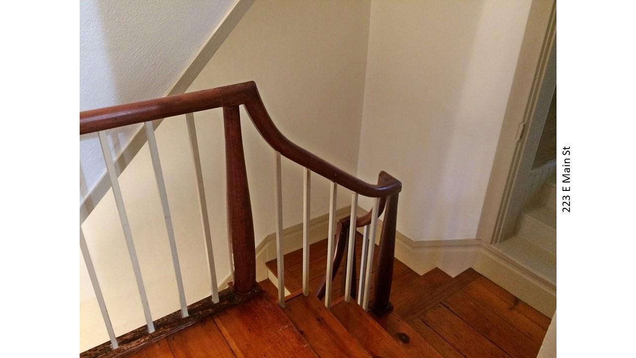 Wooden staircase with white balusters
