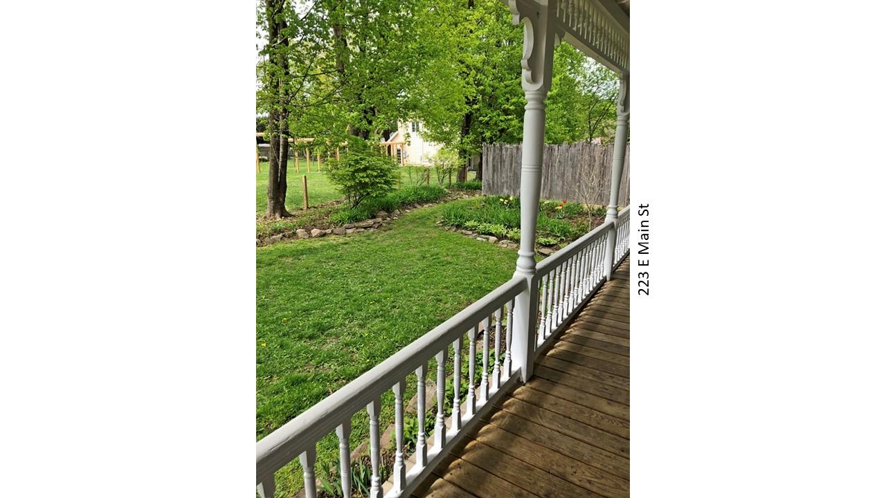 Porch view of green lawn and trees