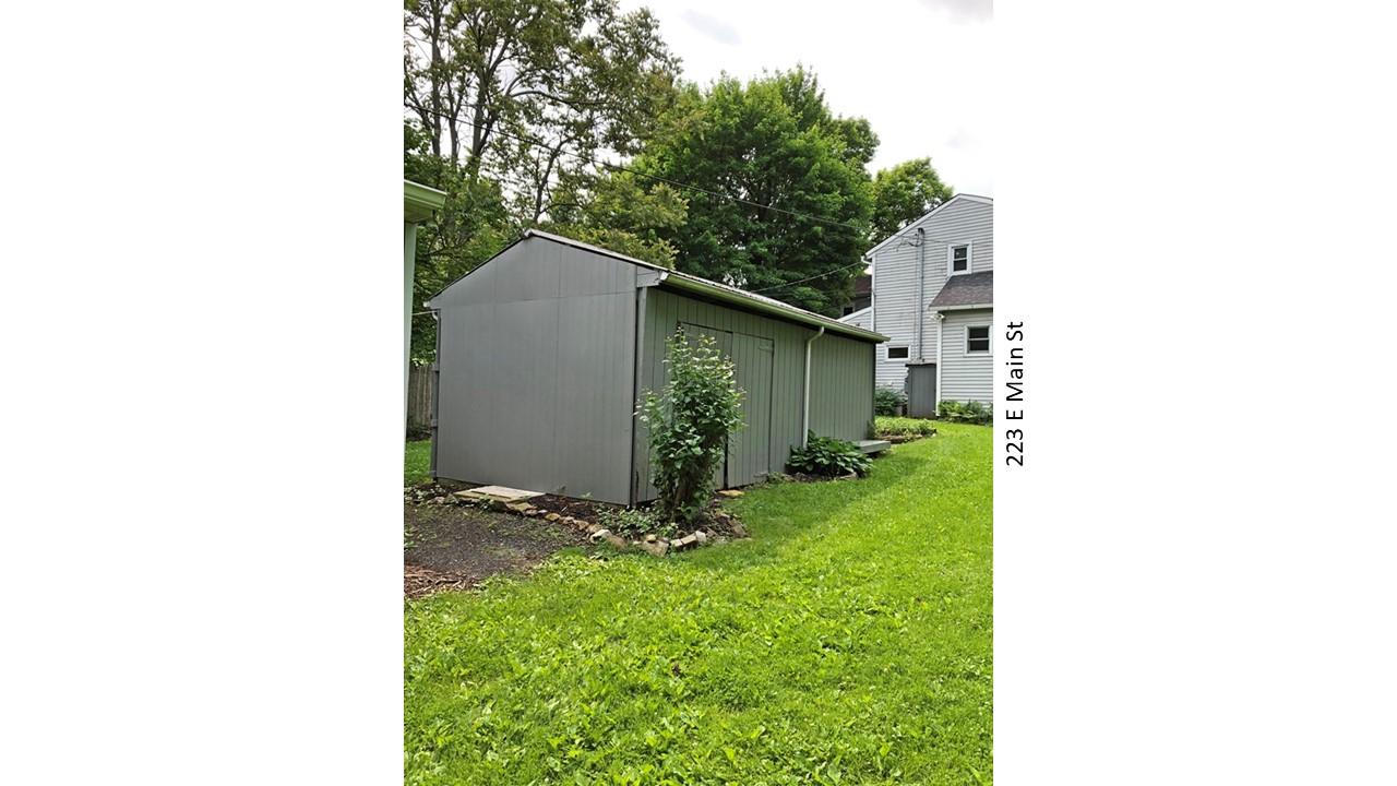 Gray shed at 223 E Main St