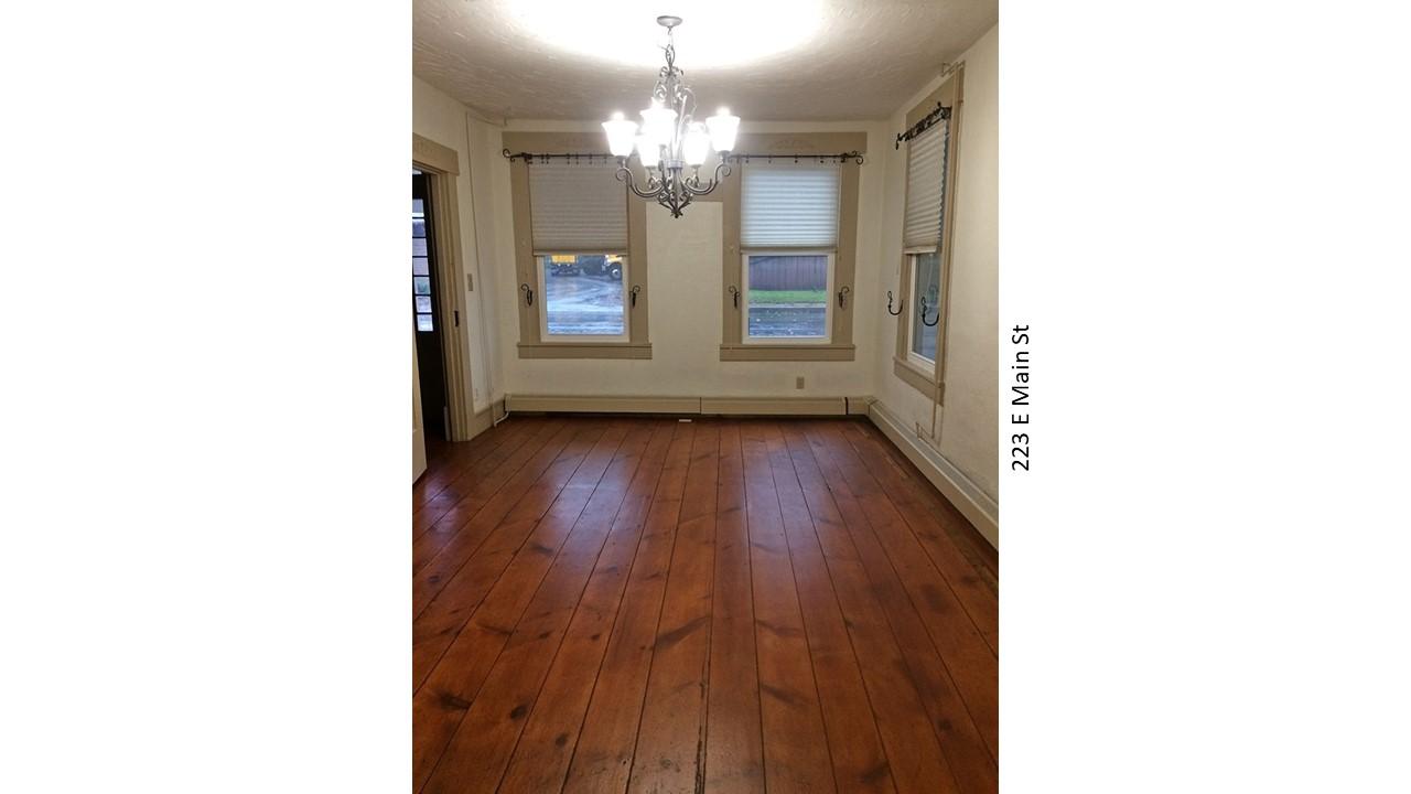 Dining room with wood floors and chandelier