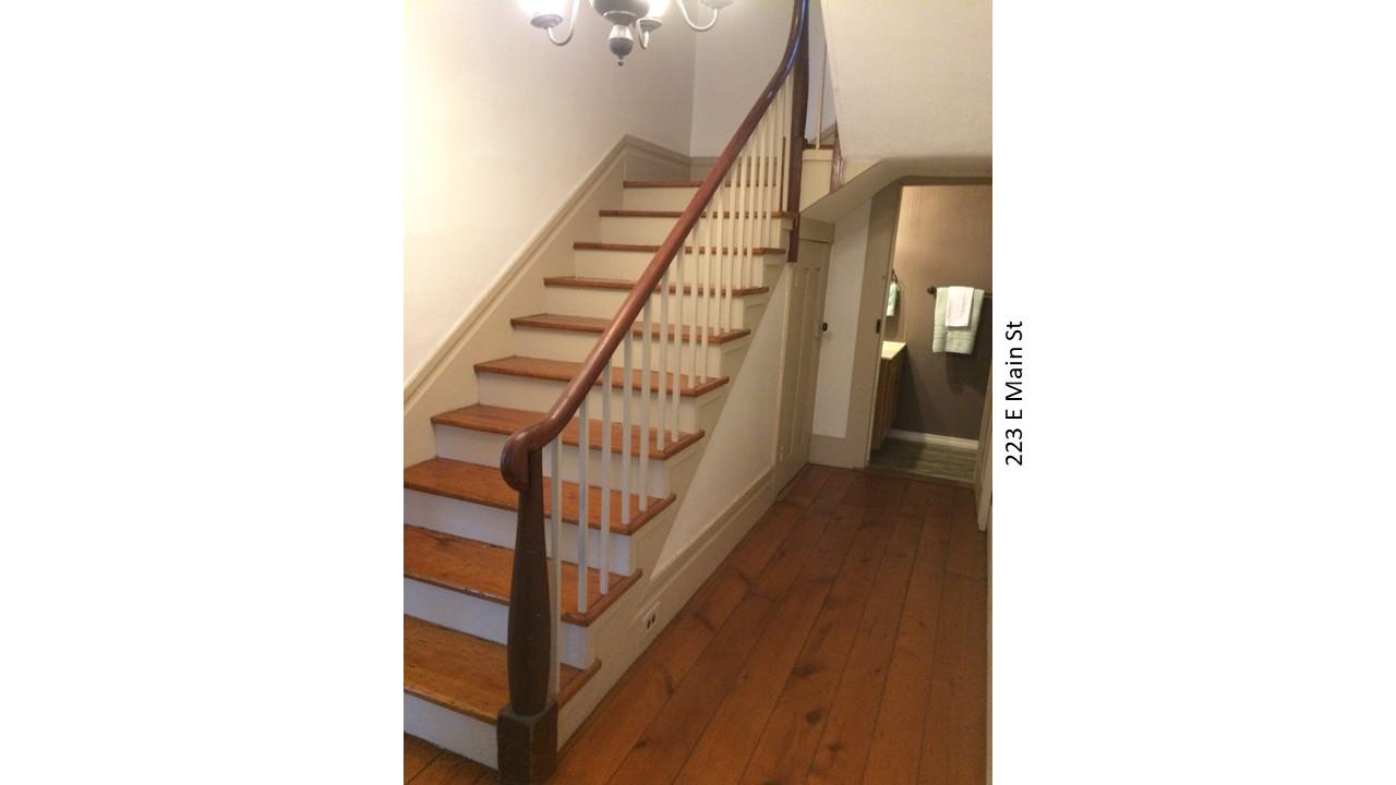 Staircase with wooden banister in historic home