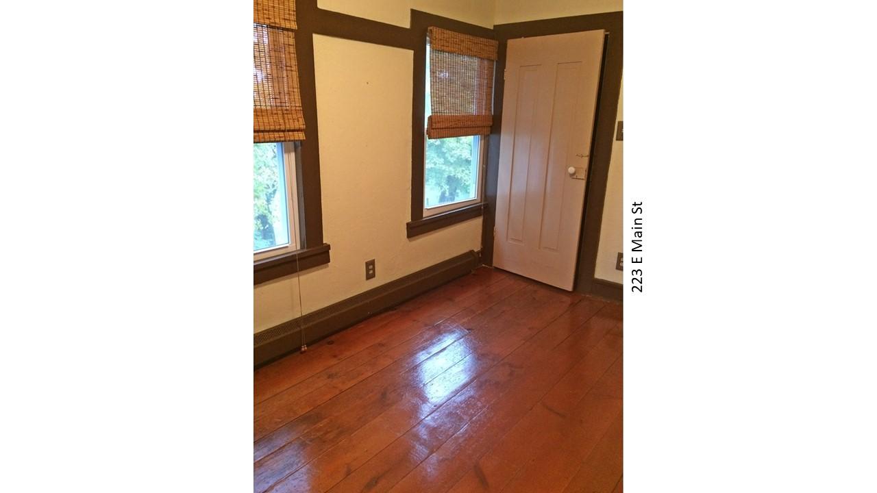 Interior room with wood floors and door
