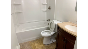 Bathroom with tub/shower combo, toilet, and vanity