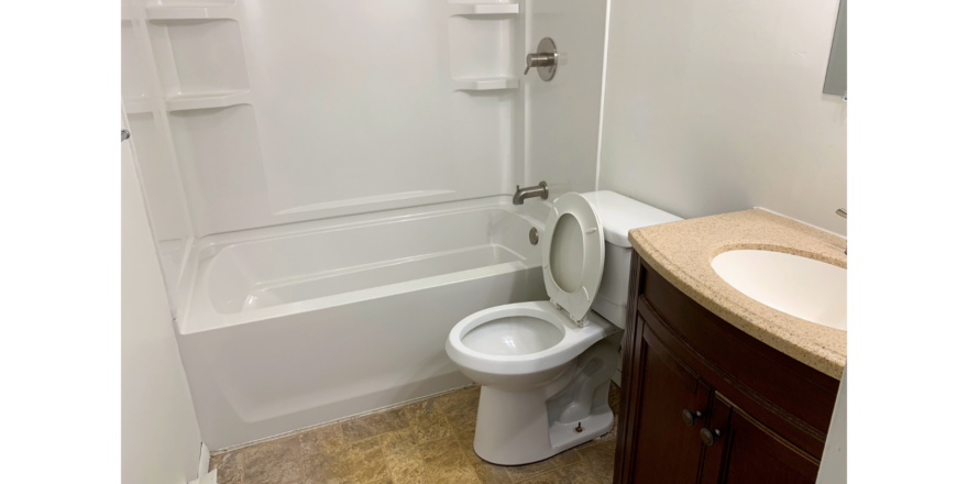 Bathroom with tub/shower combo, toilet, and vanity