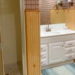Bathroom with shower stall and vanity