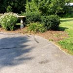 Driveway with bushes and birdbath