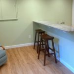 Kitchen counter with barstool seating and a recliner