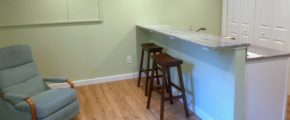 Kitchen counter with barstool seating and a recliner