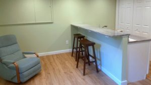 Kitchen counter with barstool seating and a recliner