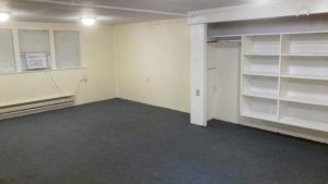 Unfurnished, carpeted bedroom with built in shelving