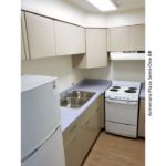 Kitchen with double sink, refrigerator, and range oven
