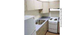 Kitchen with double sink, refrigerator, and range oven