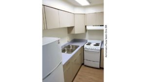 Kitchen with double sink, refrigerator, and range oven