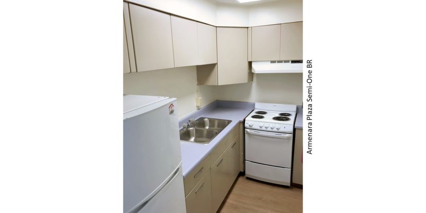 Kitchen with double sink, refrigerator, and range oven