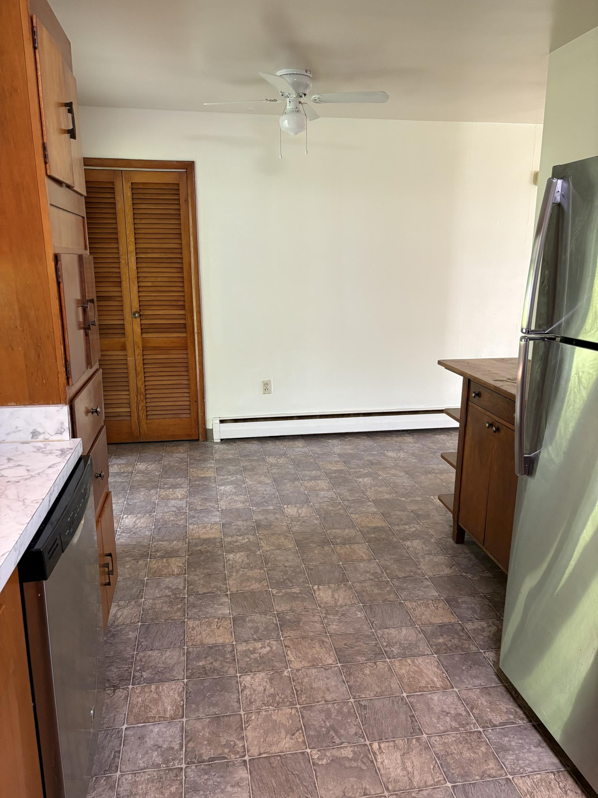 Kitchen with wood cabinets and stainless steel fridge