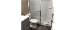 Bathroom with stall shower, toilet, and vanity