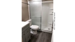 Bathroom with stall shower, toilet, and vanity