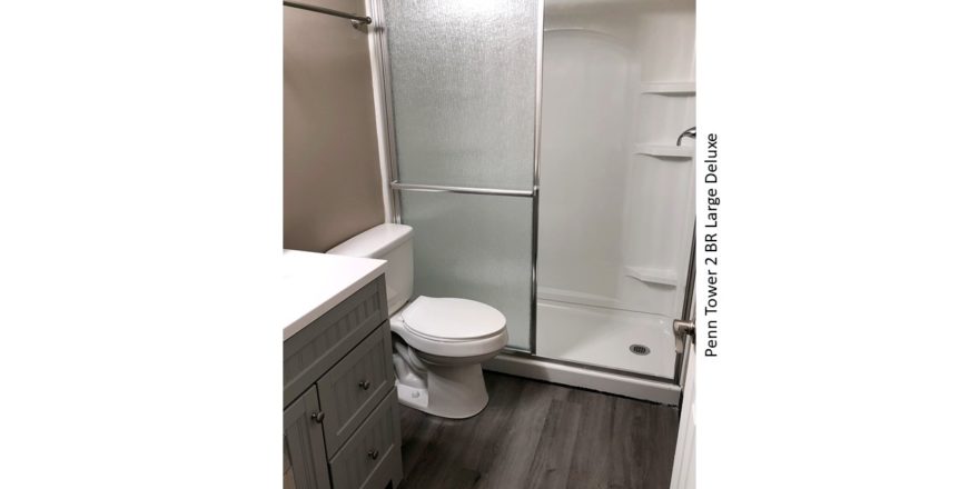 Bathroom with stall shower, toilet, and vanity