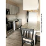 Kitchen with stainless steel appliances and counter seating