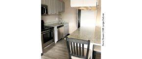 Kitchen with stainless steel appliances and counter seating