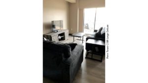 Living room with sofa, loveseat, tv, tv stand, coffee table, side table and door to balcony