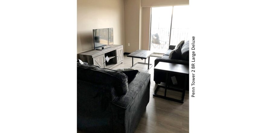 Living room with sofa, loveseat, tv, tv stand, coffee table, side table and door to balcony