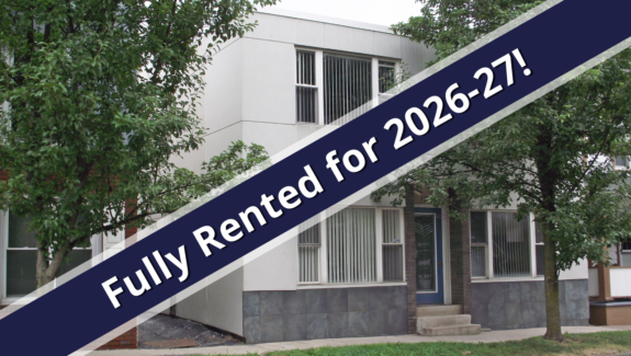 a blue and white ribbon is in front of a house